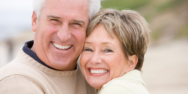 An older couple smiling proudly after restorative dentistry in Casper.